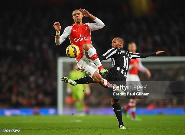 Kieran Gibbs of Arsenal challenges for the ball with Yoan Gouffran of Newcastle United during the Barclays Premier League match between Arsenal and...