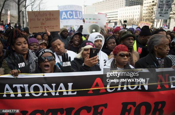 Reverend Al Sharpton and Lesley McSpadden , mother of Ferguson shooting victim Michael Brown, lead the "Justice For All" march in Washington, DC,...