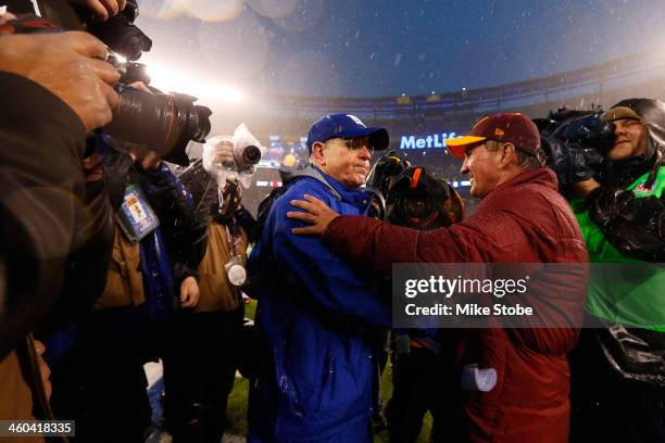 Head coach Tom Coughlin of the New York Giants and head coach Mike Shanahan of the Washington Redskins shake hands following the game at MetLife...