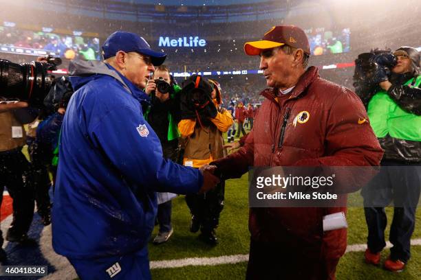 Head coach Tom Coughlin of the New York Giants and head coach Mike Shanahan of the Washington Redskins shake hands following the game at MetLife...