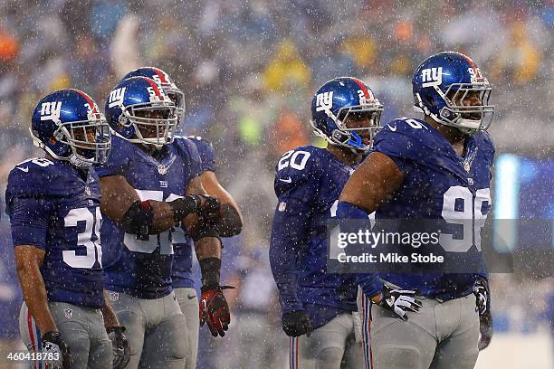 Johnathan Hankins, Prince Amukamara, Trumaine McBride and Jon Beason of the New York Giants in action against the Washington Redskins at MetLife...