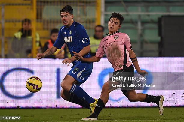 Paulo Dybala of Palermo and Francesco Acerbi of Sassulolo compete for the ball during the Serie A match between US Citta di Palermo and US Sassuolo...