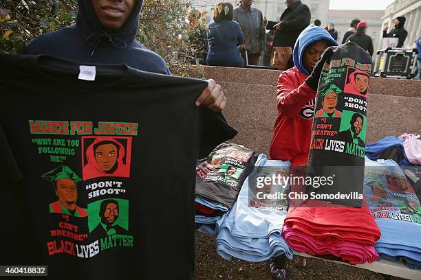 Street vndors sell t-shirts with the images of Eric Garner, Michael Brown and others unarmed black men who were killed by police during the "Justice...