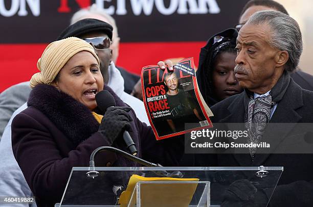 Kadiatou Diallo, mother of Amadou Diallo, holds a 14-year-old copy of Time magazine with an image of her son on the cover while addressing the...