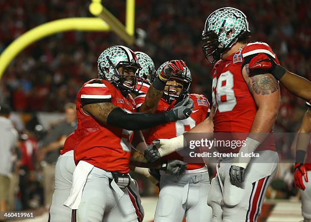Braxton Miller, Devin Smith and Taylor Decker of the Ohio State Buckeyes celebrate after a touchdown by Miller in the second quarter against the...