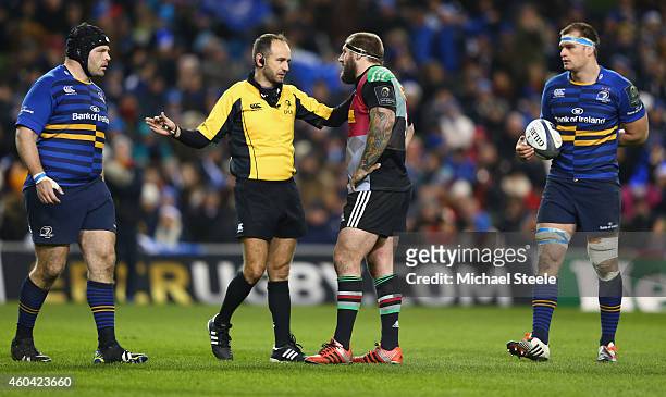 Referee Romain Poite of France rules out a try scored by Mike Brown as Joe Marler the captain of Harlequins listens during the European Rugby...