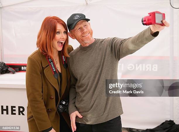 Actress Bryce Dallas Howard, with filmmaker Ron Howard, hosts the Canon Let It Snow Globe spectacle at Hollywood & Highland on December 13, 2014 in...