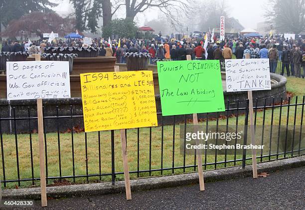 Protest signs, including one stating contributions from Michael Bloomberg, Bill Gates, Paul Allen, Nick Hanauer, Steve Ballmer and Jim Senegal, are...