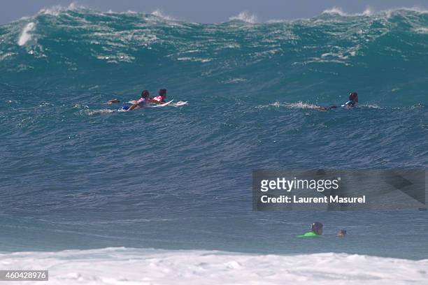 Dion Atkinson , Julian Wilson and Aritz Aranburu surfs during round 2 of the Billabong Pipe Masters on December 13, 2014 in North Shore, Hawaii.
