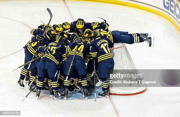 Justin Selman of the Michigan Wolverines hangs over the back of the net before NCAA hockey against the Boston College Eagles at Kelley Rink on...