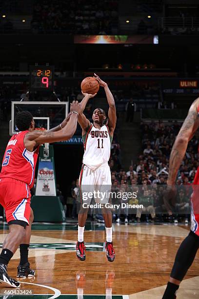 Brandon Knight of the Milwaukee Bucks shoots against DeAndre Jordan of the Los Angeles Clippers on December 13, 2014 at the BMO Harris Bradley Center...