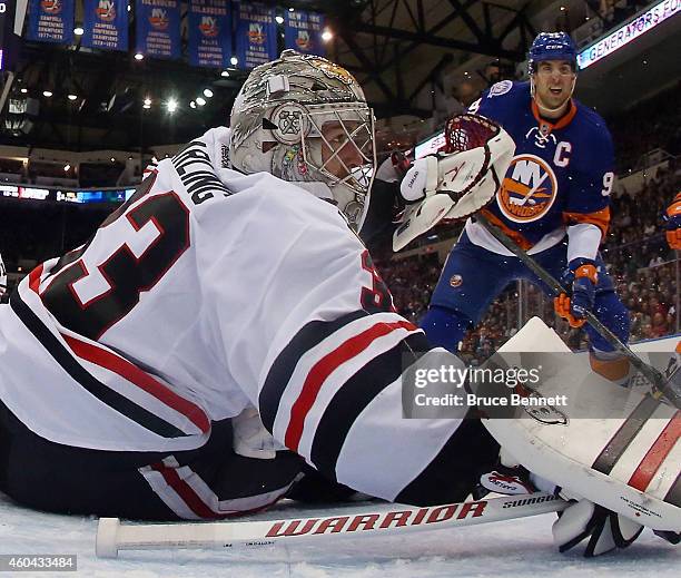 Scott Darling of the Chicago Blackhawks tends net against John Tavares of the New York Islanders at the Nassau Veterans Memorial Coliseum on December...