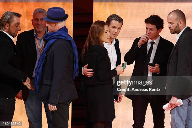 Host Markus Lanz and his wife Angela Gessmann speak to crew members after the last broadcast of the Wetten, dass..?? tv show on December 13, 2014 in...