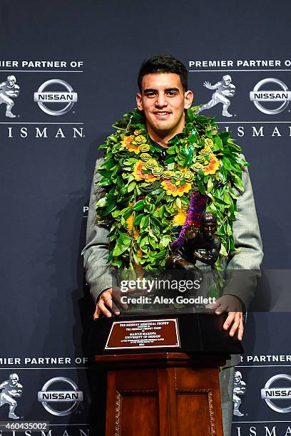 Oregon Ducks quarterback Marcus Mariota poses with the Heisman Trophy during a press conference after the 2014 Heisman Trophy presentation at the New...