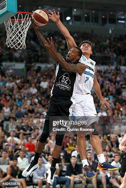 Jordan McRae of United shoots whilst Reuben Te Rangi of the Breakers attempts to block during the round 10 NBL match between Melbourne United and the...