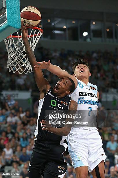 Jordan McRae of United shoots whilst Reuben Te Rangi of the Breakers attempts to block during the round 10 NBL match between Melbourne United and the...