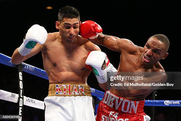 Amir Khan takes a right hand from Devon Alexander during their welterweight bout at the MGM Grand Garden Arena on December 13, 2014 in Las Vegas,...