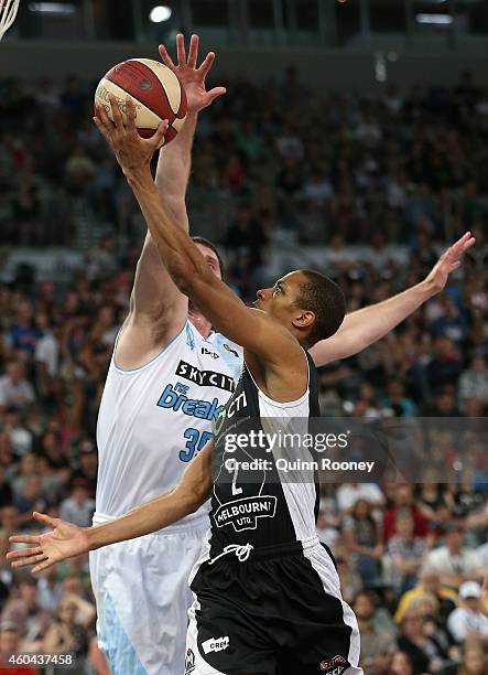 Stephen Dennis of United shoots whilst Alex Pledger of the Breakers attempts to block during the round 10 NBL match between Melbourne United and the...