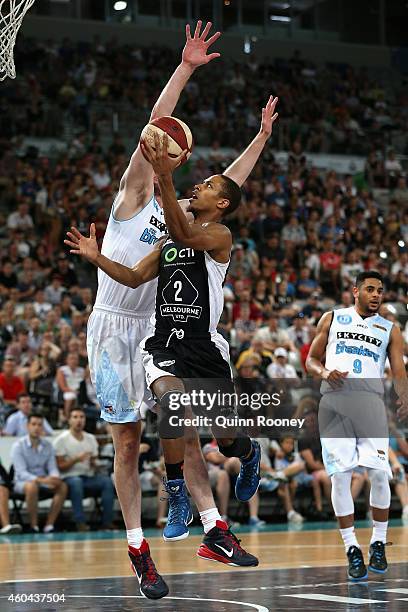 Stephen Dennis of United shoots whilst Alex Pledger of the Breakers attempts to block during the round 10 NBL match between Melbourne United and the...