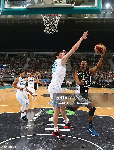 Stephen Dennis of United shoots whilst Alex Pledger attempts to block during the round 10 NBL match between Melbourne United and the New Zealand...