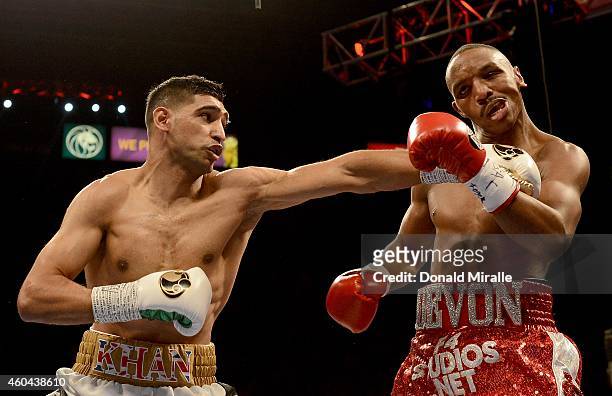 Amir Khan hits Devon Alexander during their welterweight bout at the MGM Grand Garden Arena on December 13, 2014 in Las Vegas, Nevada. Khan won with...