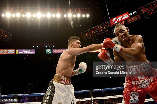 Amir Khan hits Devon Alexander during their welterweight bout at the MGM Grand Garden Arena on December 13, 2014 in Las Vegas, Nevada. Khan won with...