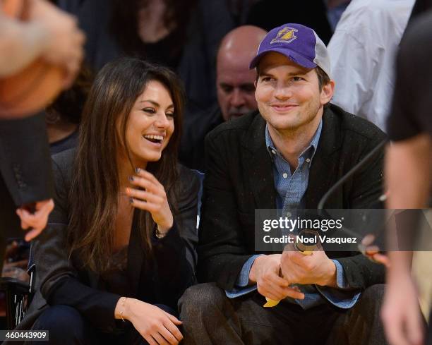 Ashton Kutcher and Mila Kunis attend a basketball game between the Utah Jazz and the Los Angeles Lakers at Staples Center on January 3, 2014 in Los...