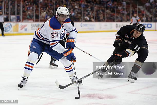 David Perron of the Edmonton Oilers is pursued by Ryan Getzlaf of the Anaheim Ducks for the puck in the first period at Honda Center on January 3,...