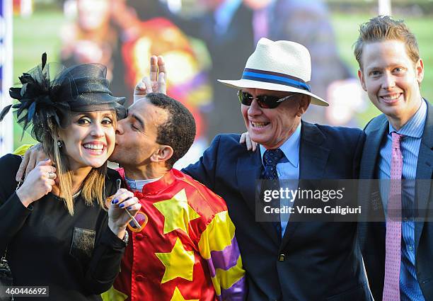 Trainer John Moore and son George pose with Joao Moreira as he kisses his wife Tasciana Moreira after riding Designs on Rome to win in Race 8, The...