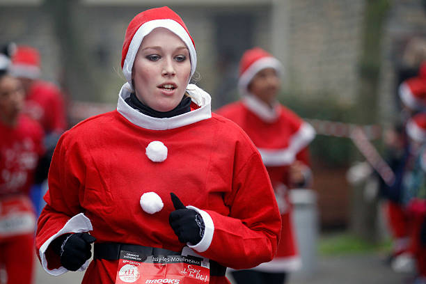 FRA: Thousands Of Runners Dressed In Santa Claus Outfits At The Annual Christmas Corrida At Issy-les-Moulineaux