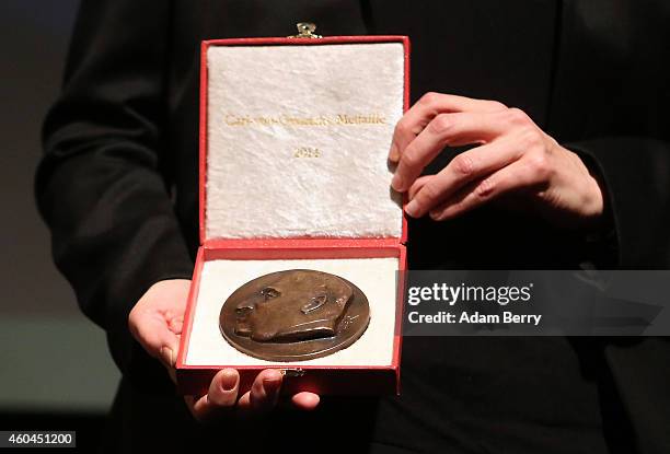 Filmmaker Laura Poitras holds her medal during an award ceremony for the Carl von Ossietzky journalism prize on December 14, 2014 in Berlin, Germany....