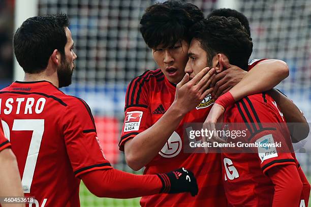 Hakan Calhanoglu of Leverkusen celebrates his team's first goal with team mates Heung-Min Son and Gonzalo Castro during the Bundesliga match between...