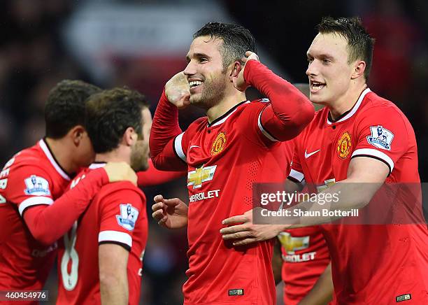 Robin van Persie of Manchester United celebrates scoring the third goal during the Barclays Premier League match between Manchester United and...