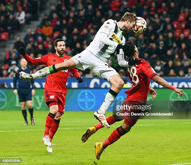 Christoph Kramer of Moenchengladbach is challenged by Wendell and Gonzalo Castro of Leverkusen during the Bundesliga match between Bayer 04...