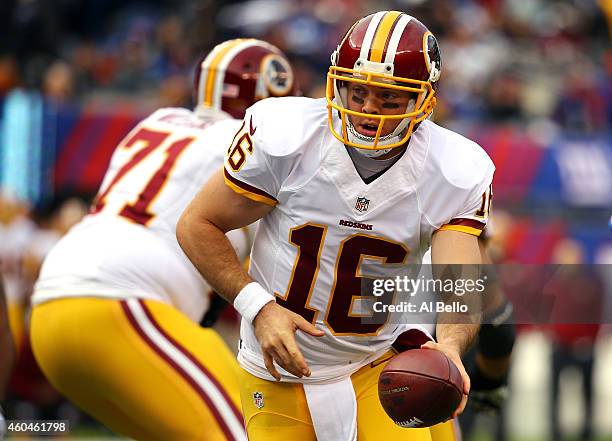 Colt McCoy of the Washington Redskins hands the ball off in the first quarter against the New York Giants during their game at MetLife Stadium on...