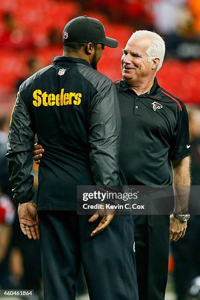 Head coach Mike Smith of the Atlanta Falcons talks to head coach Mike Tomlin of the Pittsburgh Steelers on the field prior ot the game at the Georgia...