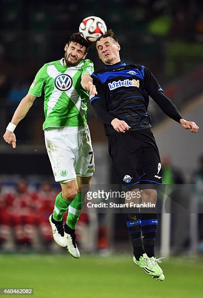 Stefan Kutschke of Paderborn jumps for a header with Daniel Caligiuri of Wolfsburg during the Bundesliga match between VfL Wolfsburg and SC Paderborn...