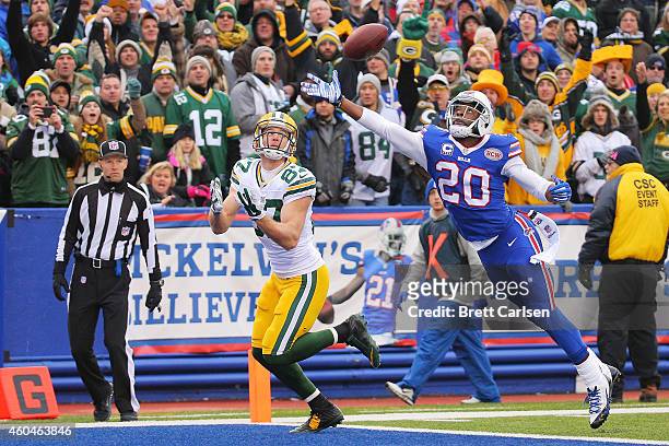 Jordy Nelson of the Green Bay Packers has a reception broken up by Corey Graham of the Buffalo Bills during the first half at Ralph Wilson Stadium on...