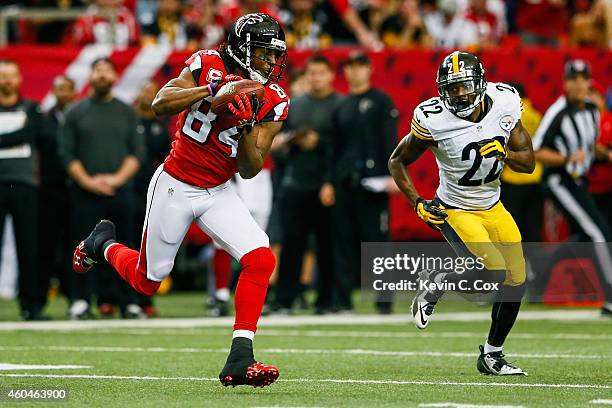 Roddy White of the Atlanta Falcons catches a pass ahead of William Gay of the Pittsburgh Steelers in the first half at the Georgia Dome on December...