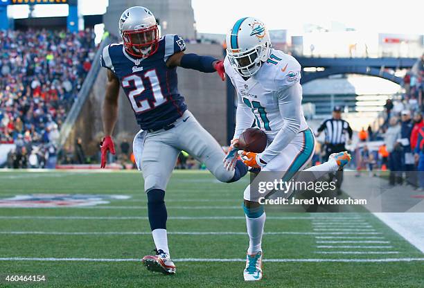 Mike Wallace of the Miami Dolphins catches a touchdown pass as Malcolm Butler of the New England Patriots defends during the second quarter at...