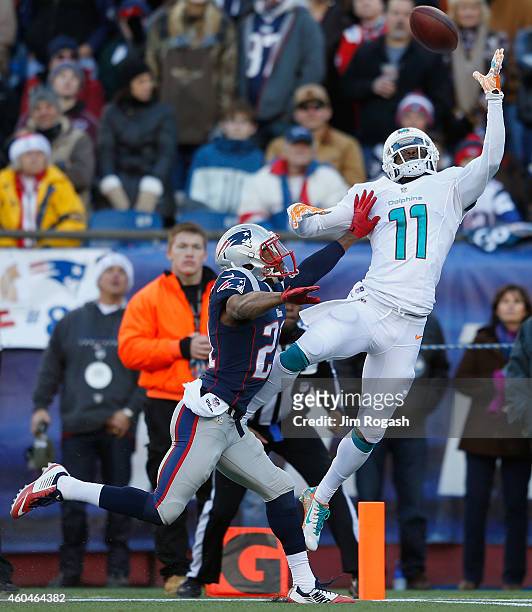 Mike Wallace of the Miami Dolphins catches a touchdown pass as Malcolm Butler of the New England Patriots defends during the second quarter at...