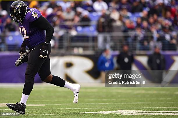 Guard Kelechi Osemele of the Baltimore Ravens runs off the field after losing his shoe against the Jacksonville Jaguars in the third quarter at M&T...