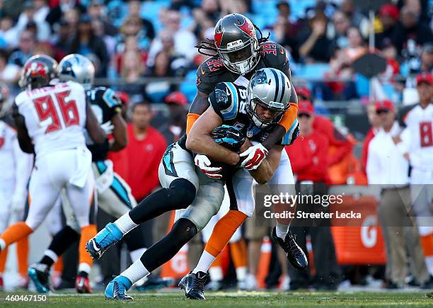 Greg Olsen of the Carolina Panthers protects the ball from Brandon Dixon of the Tampa Bay Buccaneers in the 2nd half during their game at Bank of...