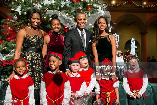 President Barack Obama , first lady Michelle Obama and daughters Sasha and Malia pose with "elves" prior to the taping of TNT's "Christmas in...