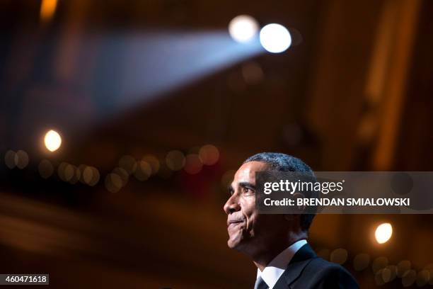 President Barack Obama speaks during a taping of the Christmas in Washington concert at the National Building Museum December 14, 2014 in Washington,...