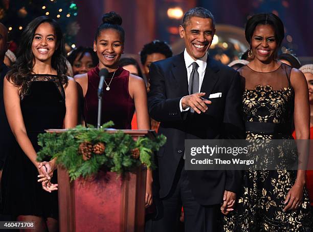 Malia Obama, Sasha Obama, U.S. President Barack Obama, and First Lady Michelle Obama speak onstage at TNT Christmas in Washington 2014 at the...