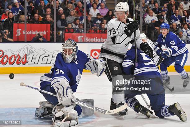 James Reimer of the Toronto Maple Leafs makes a blocker save as teammate Korbinian Holzer battles with Tyler Toffoli of the Los Angeles Kings during...
