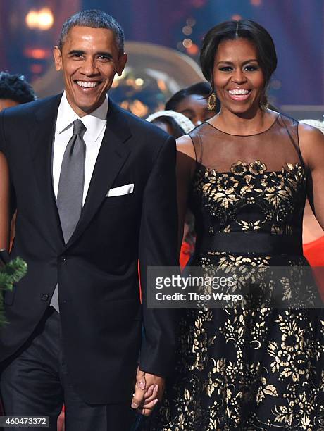 President Barack Obama and First Lady Michelle Obama speak onstage at TNT Christmas in Washington 2014 at the National Building Museum on December...