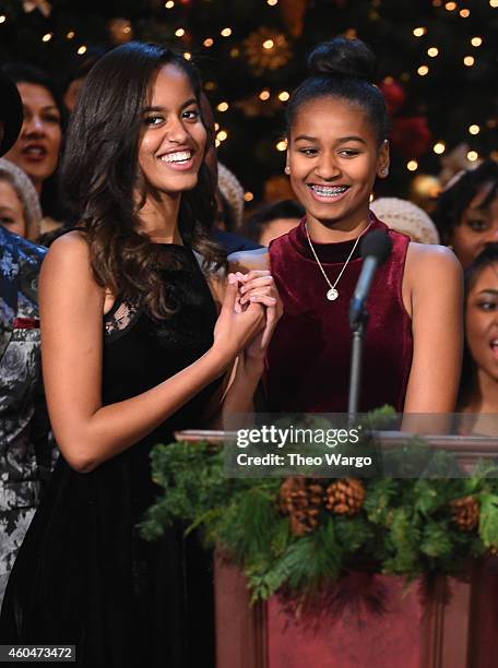 Malia Obama and Sasha Obama speak onstage at TNT Christmas in Washington 2014 at the National Building Museum on December 14, 2014 in Washington, DC....