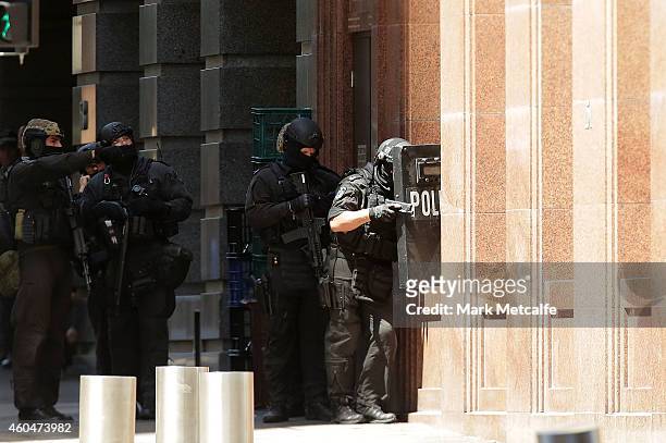 Armed policeman are seen outside Lindt Cafe on Philip St, Martin Place on December 15, 2014 in Sydney, Australia. Police attend a hostage situation...